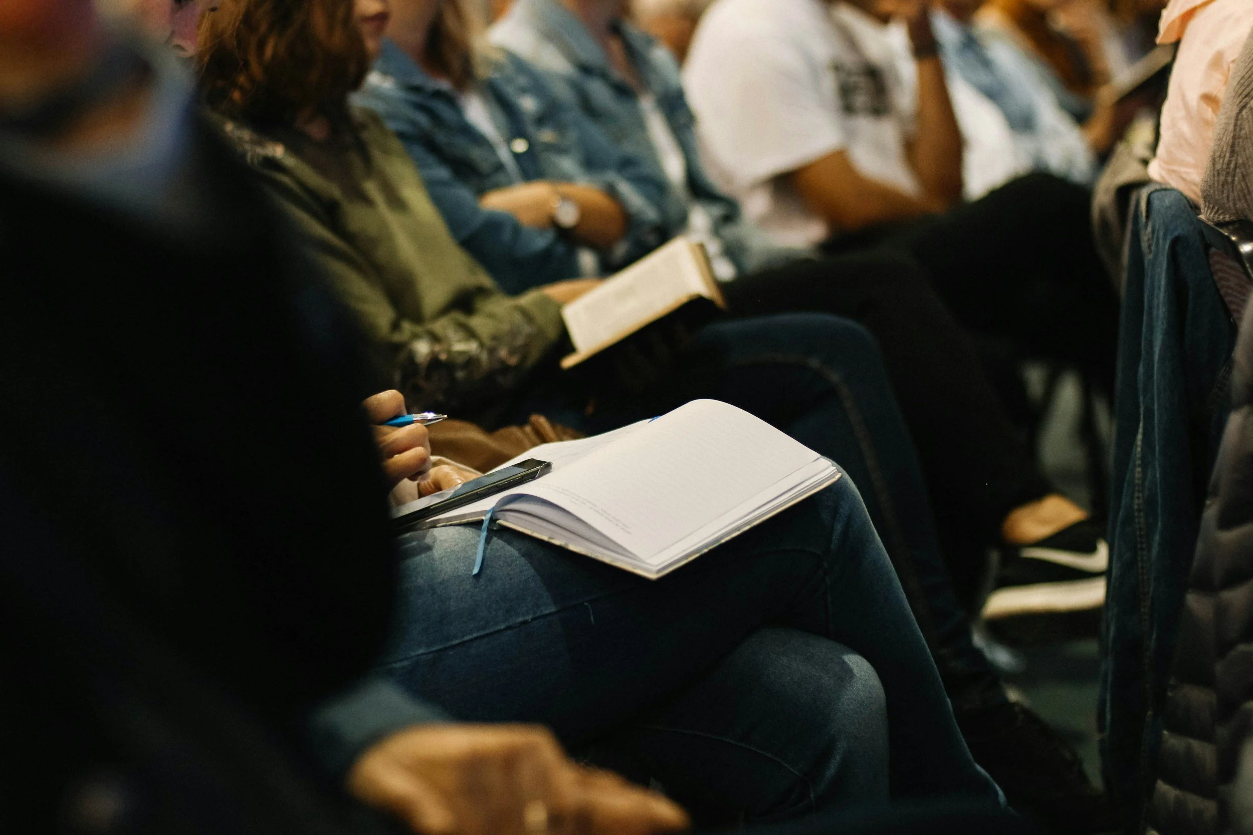 A leader taking notes during a coaching session